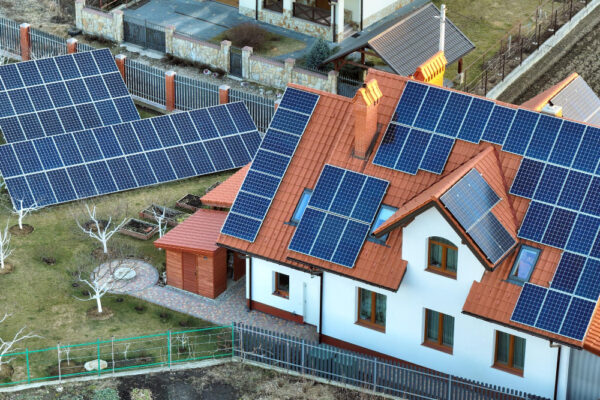 Casă cu panouri solare pe acoperiș și în curte